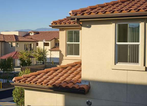 A row of houses with red tile roofs.