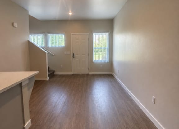 A room with wooden floors and a ceiling fan.