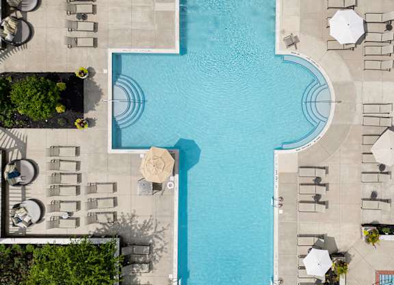 Top-down view of resort-style pool and sun deck at Princeton NJ apartments for rent
