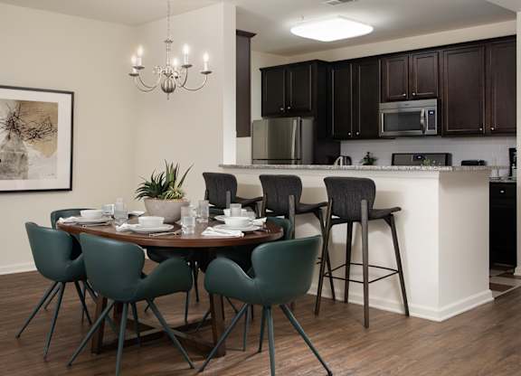 A dining room with a table set for six people.