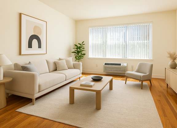 Modern Bayonne apartment living room with natural light, hardwood floors, and clean neutral finishes