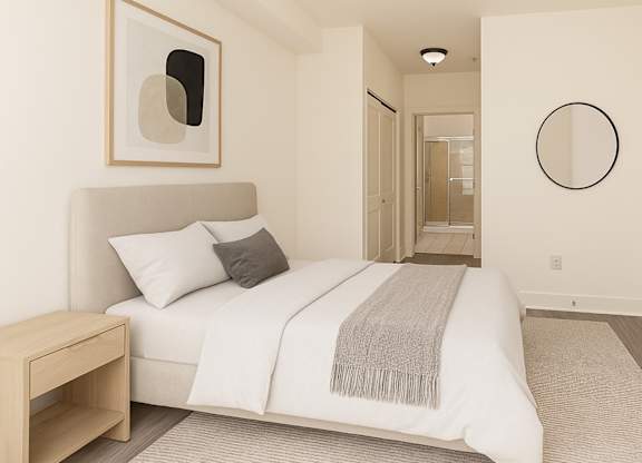 Spacious bedroom at Bridgepoint Bayonne with private bath access, wood floors, and refined details