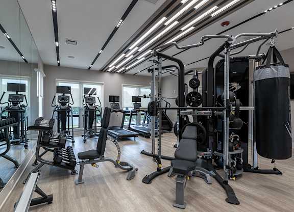 Gym with weights machines and other exercise equipment at The Crest at Princeton Meadows, Plainsboro, NJ.