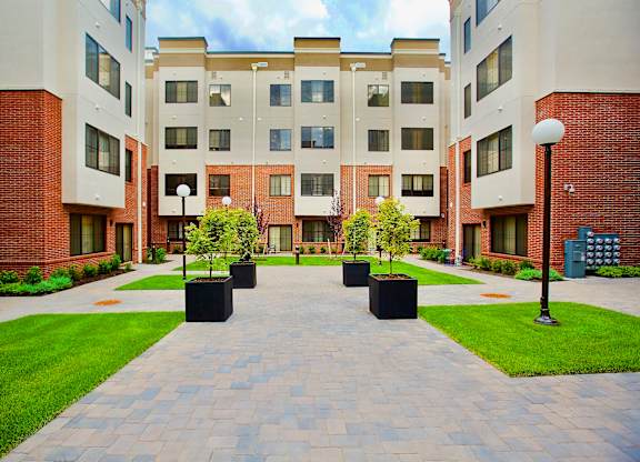 The Lofts at Middlesex courtyard view with green grass, beautiful plants, a quiet place to relax