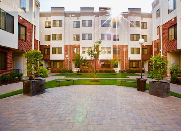The Lofts at Middlesex in Middlesex NJ courtyard view with an elegant grassy area and various plants to welcome you