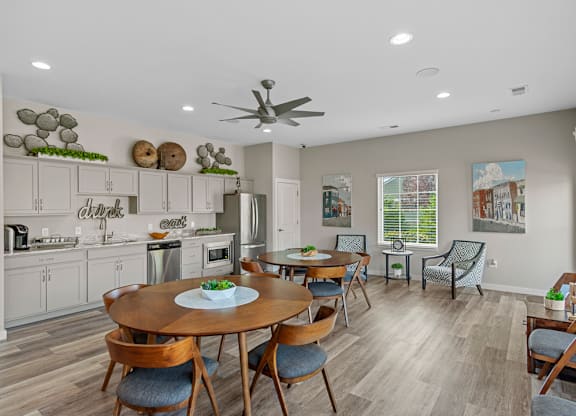 A modern kitchen with a dining table set for four.