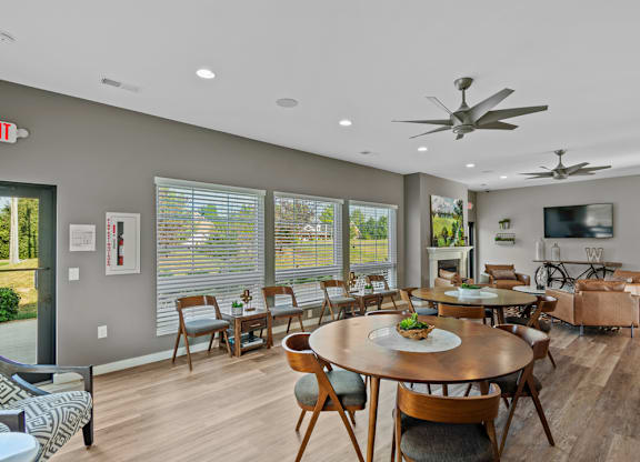 A dining room with a round table and chairs.