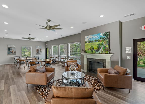 A living room with a fireplace and a painting on the wall.