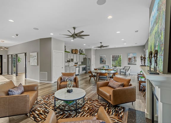 A living room with a white ceiling and a rug on the floor.