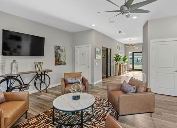 A living room with a bicycle and a flat screen TV.