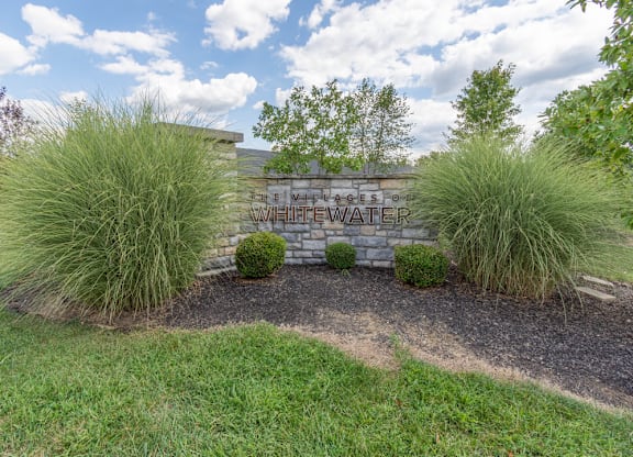 A sign that says Villages of LifeWater is surrounded by grass and plants.