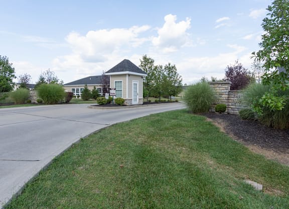 A house with a white fence and a green lawn.