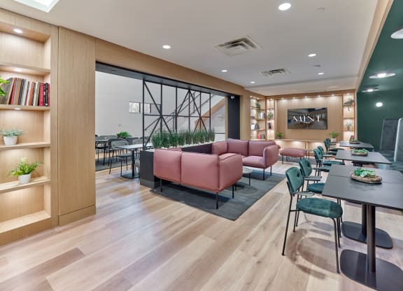 Stylish lounge area at The Mint Rahway with comfortable seating and a large screen, near Rahway Train Station and Newark Airport.