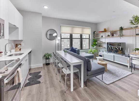 Spacious living and dining area with contemporary furnishings in a studio apartment at The Mint Rahway, offering an open floor plan for a luxury apartment rental.