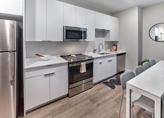 Fully equipped modern kitchen in a studio apartment at The Mint Rahway, perfect for those seeking luxury apartment rental with an open floor plan.