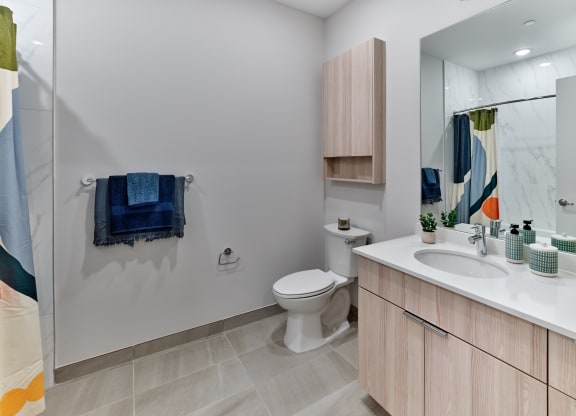 Bright and modern bathroom with elegant fixtures and ample storage space at The Mint Rahway, ideal for a luxury apartment rental.