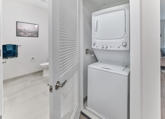 In-unit stacked washer and dryer in a spacious apartment at The Mint Rahway, perfect for convenient luxury apartment rental.