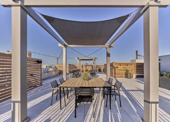Rooftop terrace at The Mint Rahway with dining and lounging areas, offering stunning views, close to Rahway Train Station and Union County Performing Arts Center.