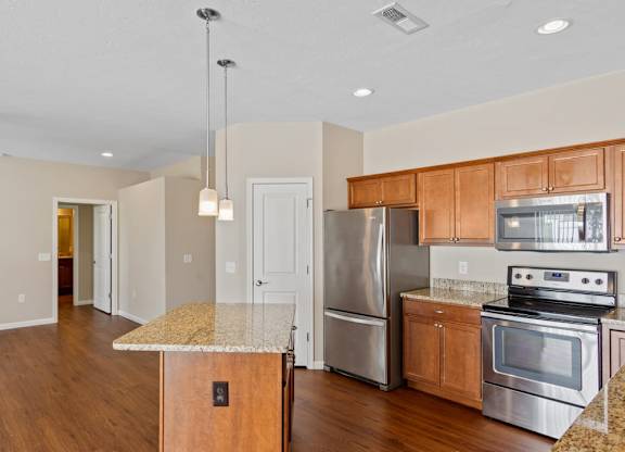 A kitchen with wooden cabinets and a granite countertop in Florence, KY