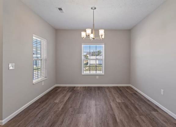 A Spacious bedroom with modern light fixture and natural light in Florence, KY