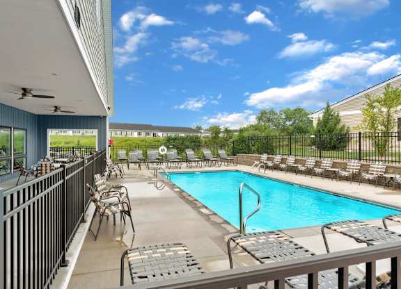 Private community pool with shaded seating for relaxation