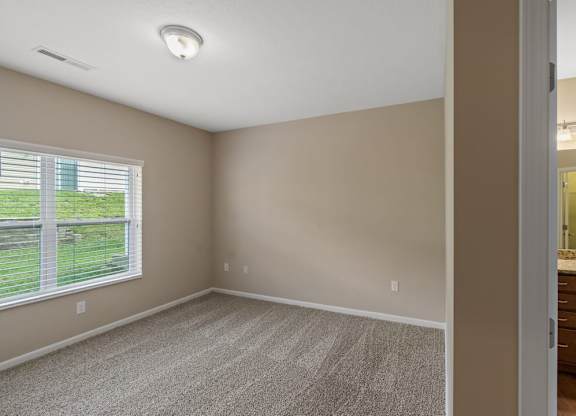 Cozy bedroom with modern lighting in a ranch-style home for rent in Florence, KY