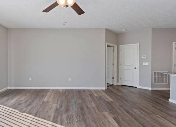 A room with a ceiling fan and wooden flooring at The Villages of Florence and Weaver Mill, KY home rentals