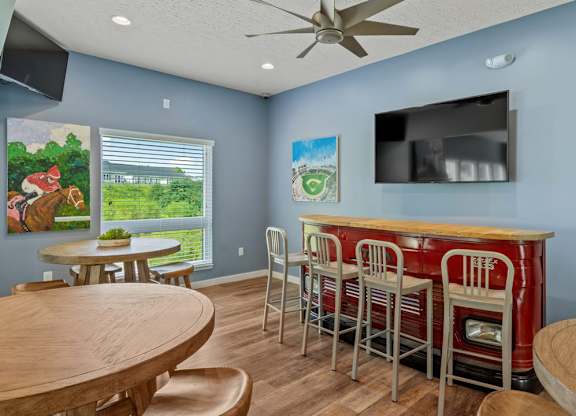 Clubhouse with a bar and TV at The Villages of Florence and Weaver Mill