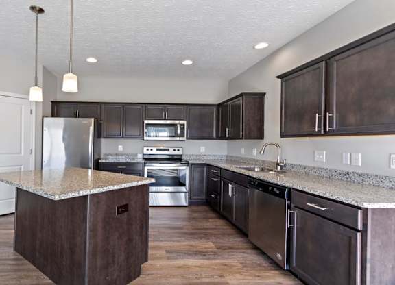 Open kitchen with granite countertops in a ranch-style rental home
