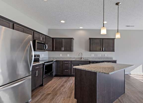 Modern kitchen with pendant lighting and stainless steel appliances in a Florence, KY rental home