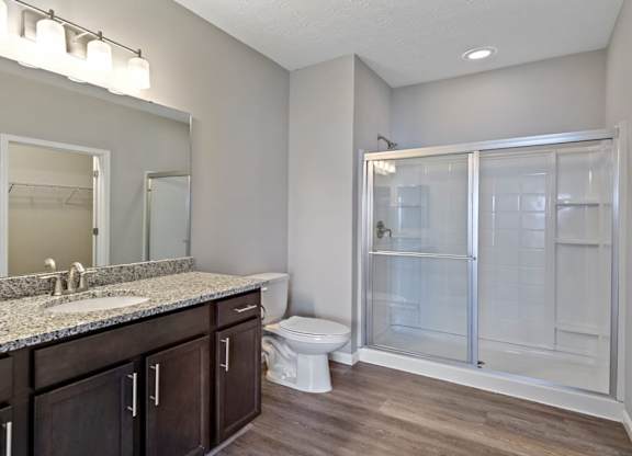 A bathroom with a sink, toilet, and shower at The Villages of Florence and Weaver Mill