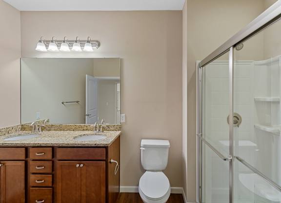 Chic bathroom with large mirror in apartments for rent near Cincinnati