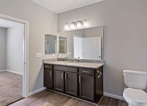Bathrooms with large mirrors and lighting at The Villages of Florence and Weaver Mill