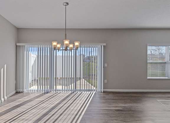 Open-concept layout with wooden flooring and large windows in Florence, KY rental homes