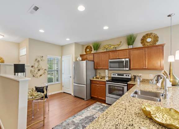 A kitchen with granite countertops and wooden cabinets in Florence, KY rental homes