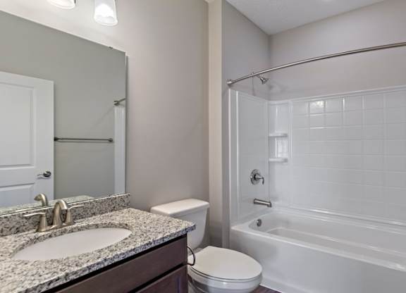 A bathroom with a white tub, sink, and toilet in Florence, KY home rentals