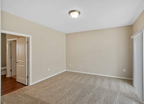 Carpeted bedrooms with lighting at The Villages of Florence and Weaver Mill