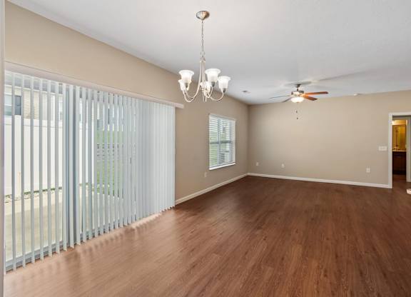A room with wooden floors and a ceiling fan at The Villages of Florence and Weaver Mill