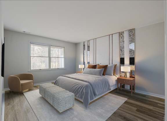 A spacious bedroom at The Village at Bridgewater in Bridgewater, NJ. Features large windows for natural light, neutral walls, and wood-style flooring for a modern and inviting atmosphere.