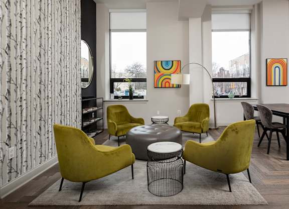 Bright and airy communal seating area with mid-century modern furniture in one of the top apartment buildings in Rittenhouse Square.