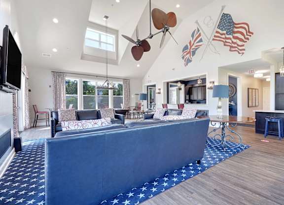 A living room with a blue carpet and a television.