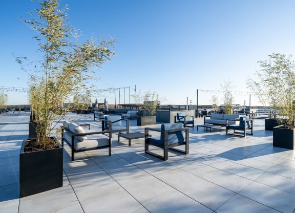 Rooftop seating area with tables and chairs at The Botanic, Carteret, NJ, 07008
