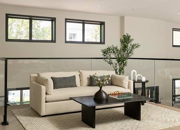 Stylish resident lounge at The Mews at Princeton Junction featuring comfortable seating and a bright, airy layout for relaxation and community gatherings.