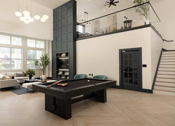 Designer lounge with a black marble fireplace and custom shelving at The Mews at Princeton Junction, offering luxurious condo-style living in Princeton NJ.
