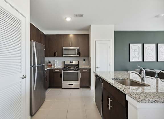 Modern kitchen with stainless steel appliances at The Lofts at Middlesex