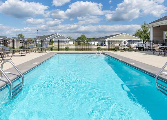 A swimming pool with a metal ladder on the side.