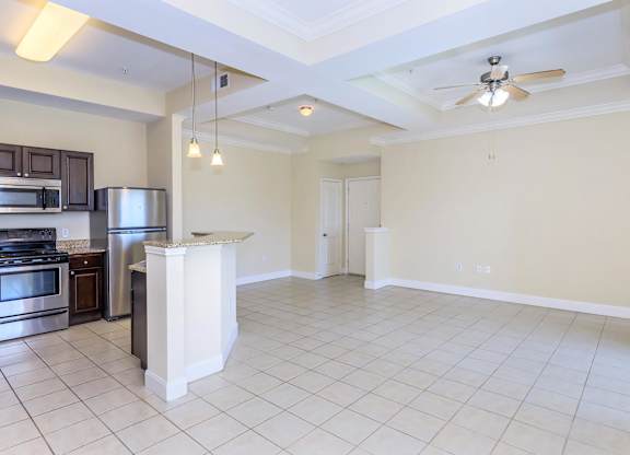 A kitchen with a stove top oven and a refrigerator.