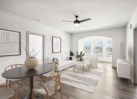 an open living room and dining room with a ceiling fan