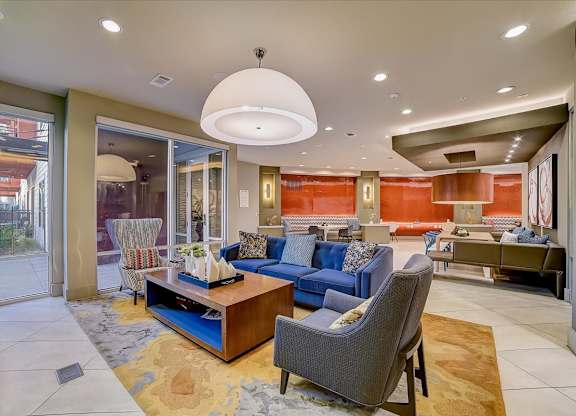 A living room with a blue couch and a brown coffee table.