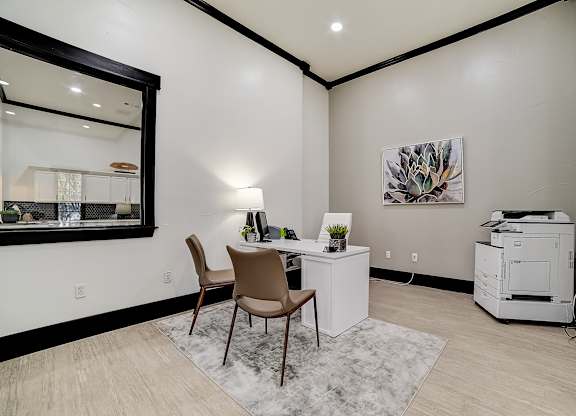 Private meeting nook with desk seating, task lamp, and printer station.
